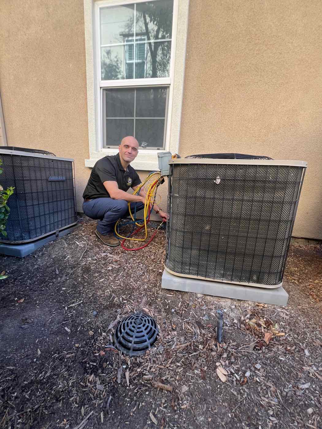 Technician working on an outdoor AC unit