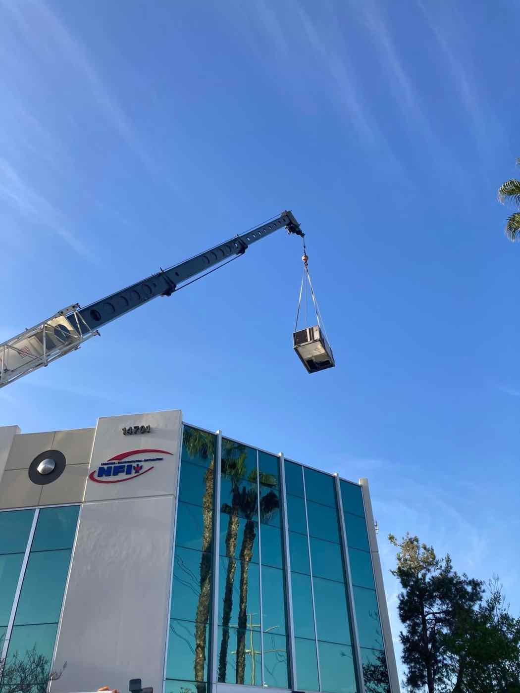 Rooftop unit lifted by crane